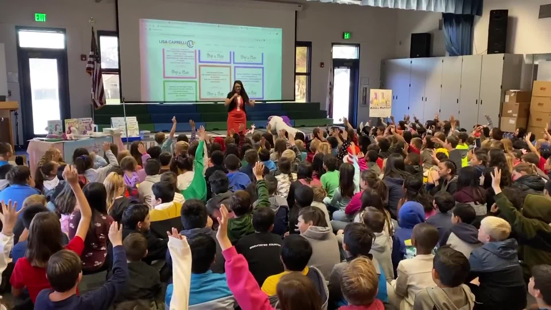 Lisa Caprelli leading an interactive assembly for a large elementary school audience