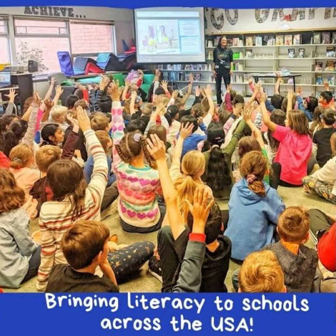 Elementary students raising their hands during a Lisa Caprelli author visit