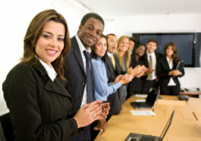 business team success clapping in an office and smiling